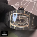 Front-facing detail of the RM 07-01’s dial, emphasizing the geometric arrangement of the hour markers and the openworked date disc. The layered construction creates depth, allowing glimpses of the movement’s balance wheel and barrel