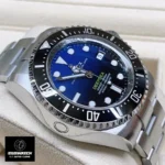 Close-up of Rolex Deepsea 136660 Super Clone's black ceramic bezel, 44mm Oyster case, and helium escape valve. Emphasizes the watch's deep-sea durability and engineering.