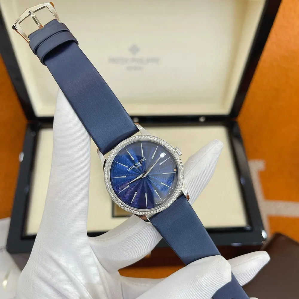 Full-view display of Patek Philippe Calatrava 4997/200G ladies watch with diamond accents and slim case.