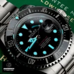 Rolex Sea-Dweller 126600 in low-light conditions, showcasing luminescent Chromalight markers and date window readability
