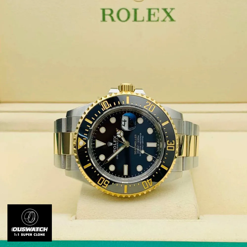 Two-tone 43mm Rolex Sea-Dweller with Oyster bracelet displayed horizontally in official green presentation box