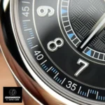 Close-up of the Calatrava 6007G-011’s carbon fiber dial and gold markers, paired with the tonal blue seconds hand.