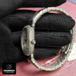 Side profile of Cartier Baignoire WJBA0020 watch highlighting curved white gold case.