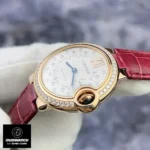 Detailed shot of the crown and diamond bezel on the Cartier rose gold ladies Ballon Bleu watch.