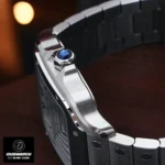 Close-up of the Cartier Santos WSSA0029 Super Clone crown featuring the blue spinel cabochon