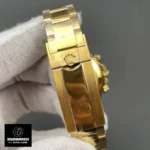 Super clone Rolex Daytona folding clasp in polished yellow gold, paired with a green dial oyster bracelet.