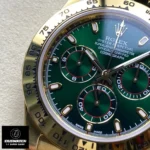 Close detail of the 18ct gold bezel and green dial on the John Mayer Rolex Daytona 116508 super clone, highlighting fluted edge and sunburst finish.
