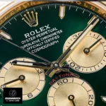 Close-up of super clone Rolex Daytona 126508’s emerald green dial, showcasing applied gold hour markers and sunburst finish.