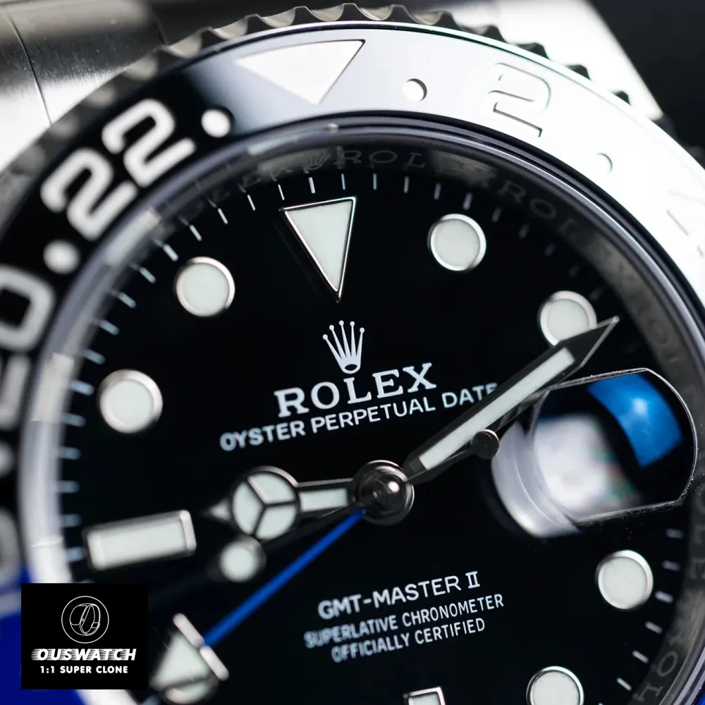 Close‑up of the black dial and bi‑color blue and black Cerachrom bezel on the Rolex GMT‑Master II 126710BLNR super clone, showing the crisp white GMT hand and luminous indices.