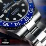 Detailed shot of the Rolex GMT‑Master II 126710BLNR super clone’s blue segment of the bezel and the brushed Oyster bracelet link, emphasizing its precision machining.