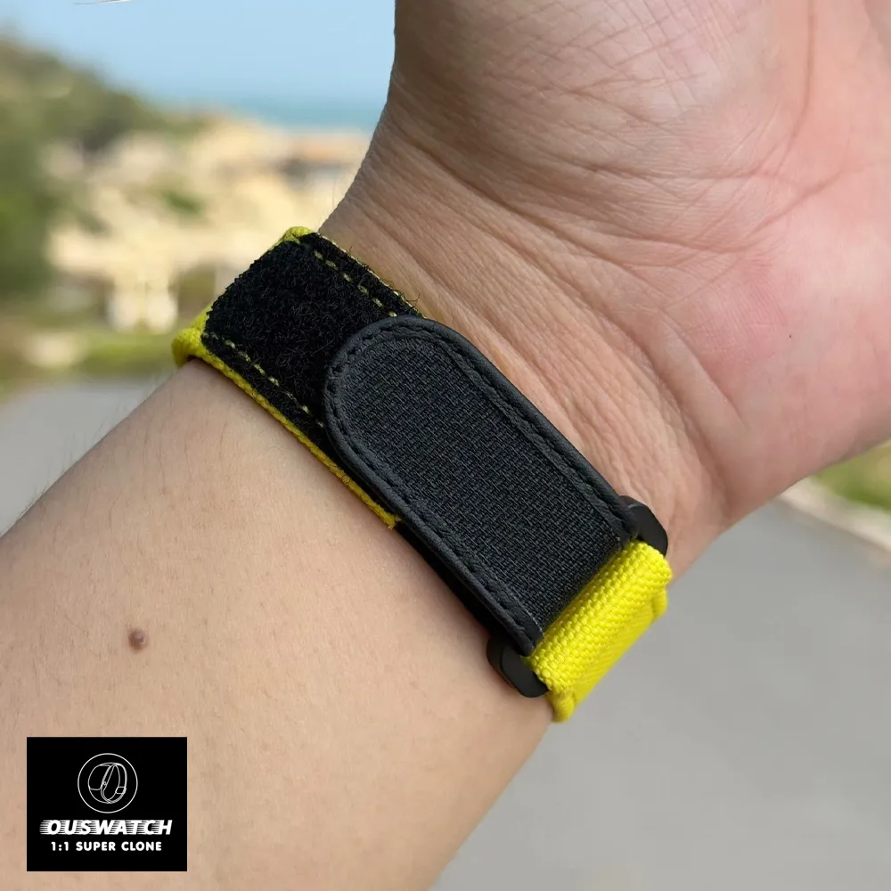 Close-up of the yellow strap of a Richard Mille RM 27‑03 super clone watch as it wraps around a wearer’s wrist.