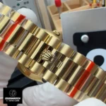 Close-up of the Rolex President bracelet on the 228238 yellow gold Day-Date watch, showing polished center links.