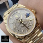 Rolex Day-Date 40 men’s watch model M228238 worn on wrist, showcasing its luxurious presence.