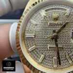 Partial view of the iced-out Rolex Day-Date 40 watch dial, showcasing diamond hour markers and fine decoration.