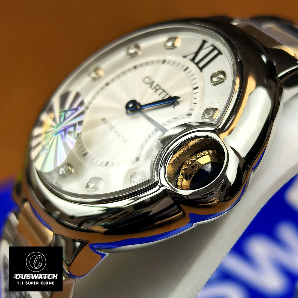 Close-up of the Cartier Ballon Bleu crown and adjacent case details, highlighting the cabochon and case finishing.