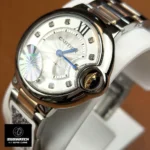 45-degree angled shot of the Cartier Ballon Bleu 33mm two-tone watch, emphasizing case curvature and dial depth.