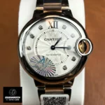 Front-facing display of the Cartier Ballon Bleu 33mm two-tone watch with silver dial, Roman numerals, and elegant bezel.