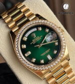 Display view of the Rolex 128348RBR Day-Date 36 watch, highlighting the fluted diamond-set bezel, green ombre dial, and yellow gold President bracelet.