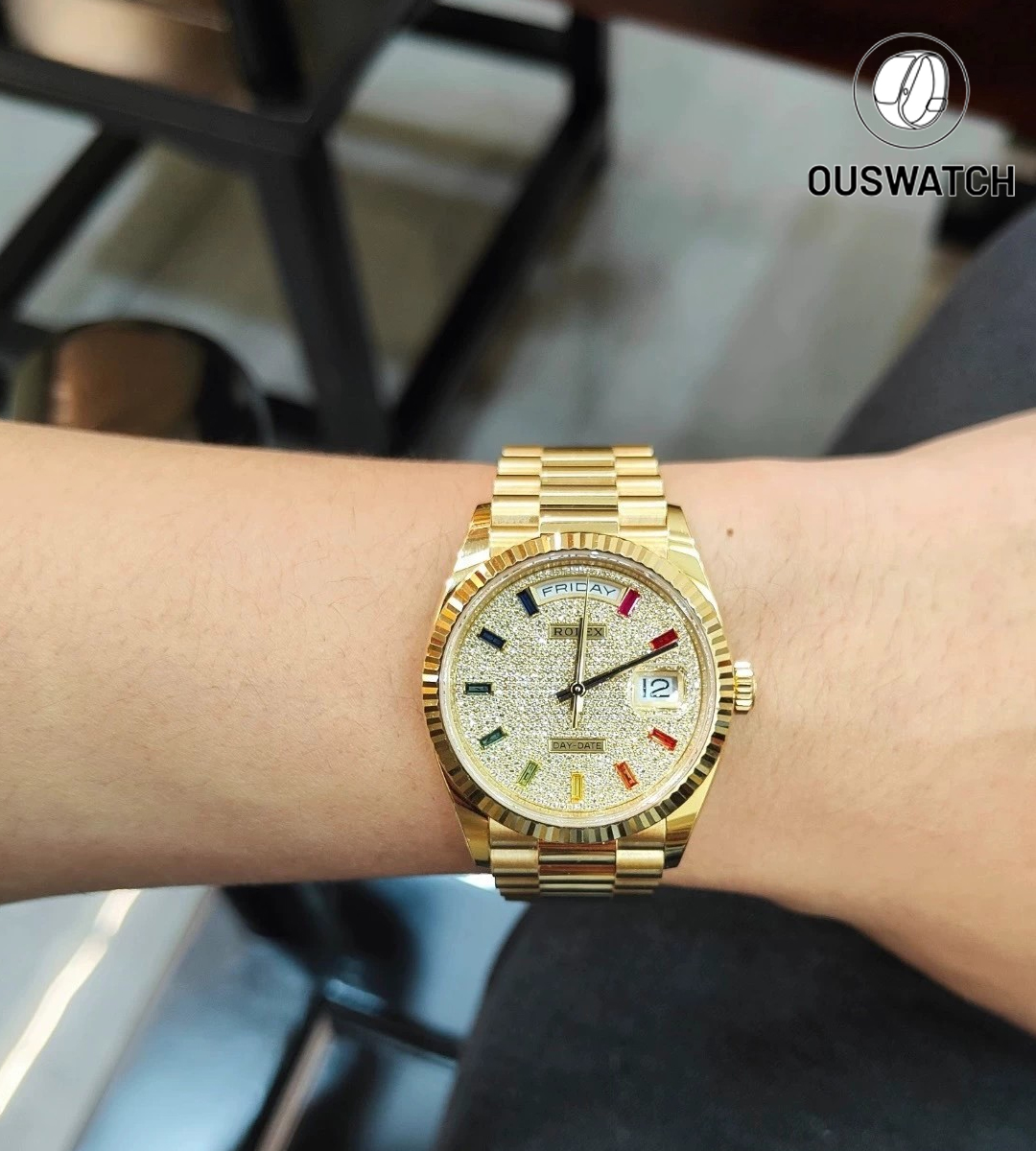 Rolex Day-Date 36 iced-out diamond watch with rainbow dial worn on wrist, showing scale and wearability