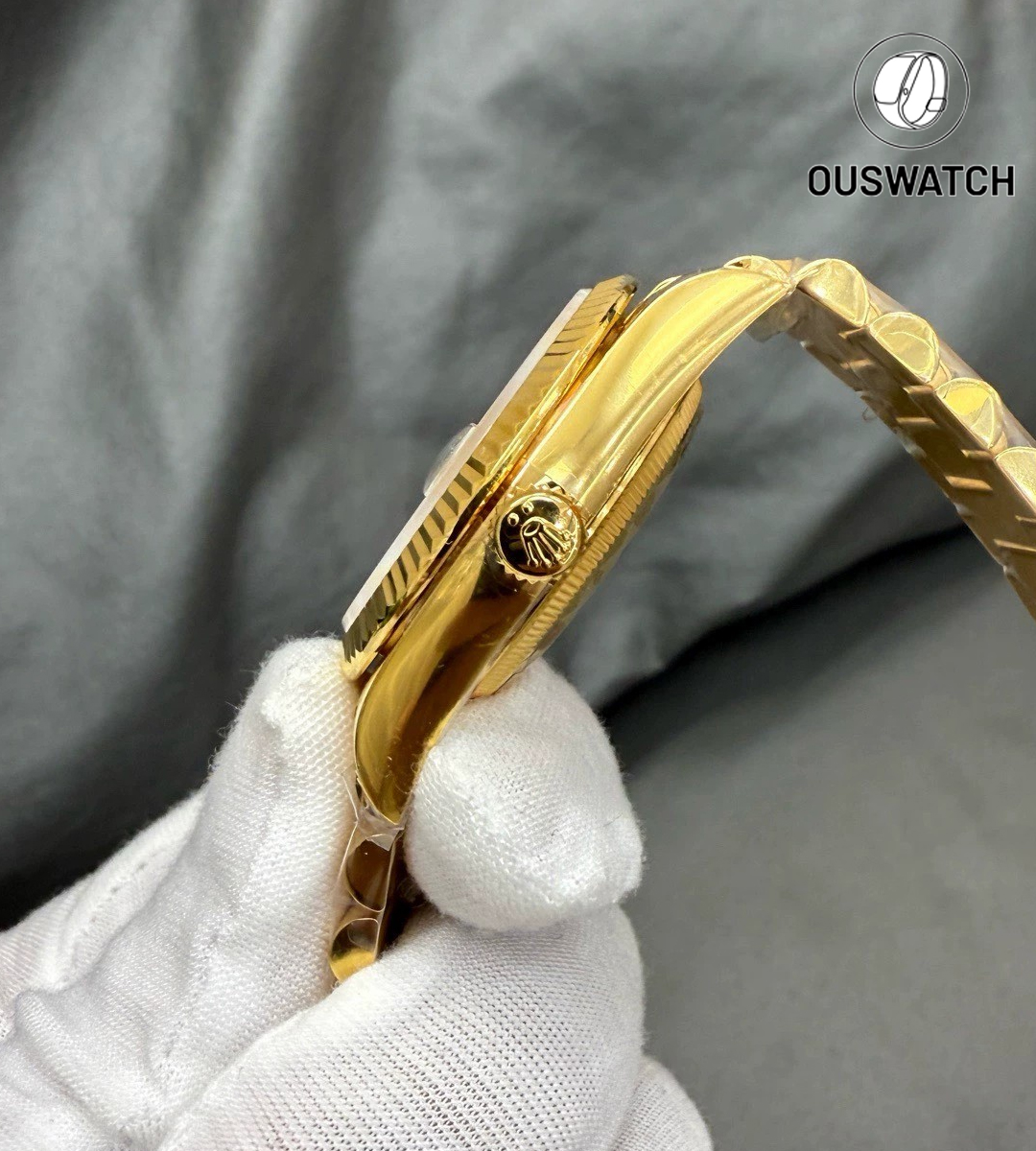 Side profile of the Rolex Day-Date 36 rainbow dial watch in yellow gold, focusing on the case curvature and screw-down crown.