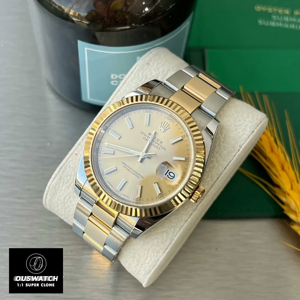 Two-Tone Rolex Datejust placed on a wooden tabletop, viewed from above to show the full watch and bracelet.