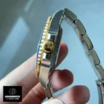 Close-up of the crown and crown guards on the Rolex Submariner blue and gold 126613LB.