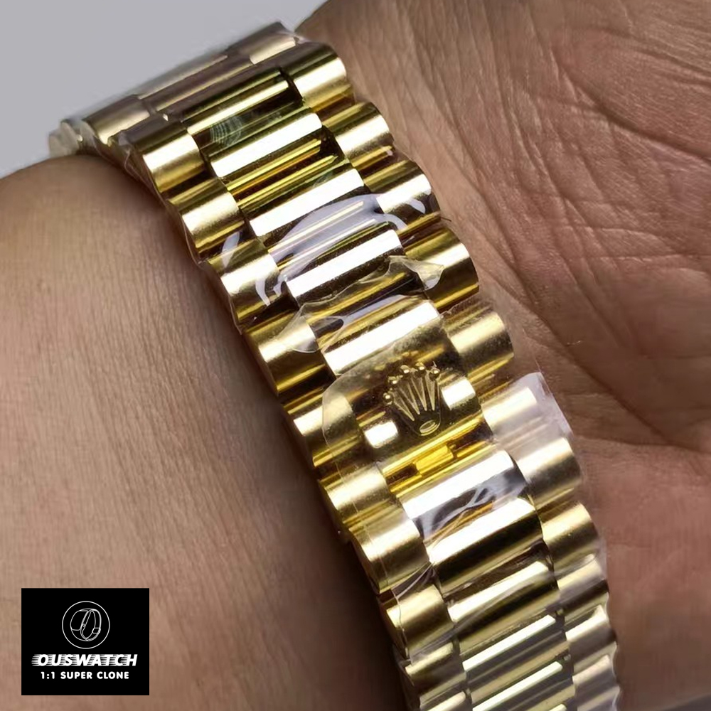 Close view of yellow gold President bracelet on Rolex 228348RBR, showing links and polished finish.