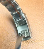 Partial close-up of the blue dial on Rolex Datejust 126200 showing hour markers and date window.