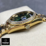 Rolex Day-Date 40 228348RBR crown and yellow gold case beside green ombre dial, detailed shot.