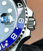 Close detail of the blue-black ceramic bezel and stainless steel case on the Rolex GMT-Master II 126710BLNR.