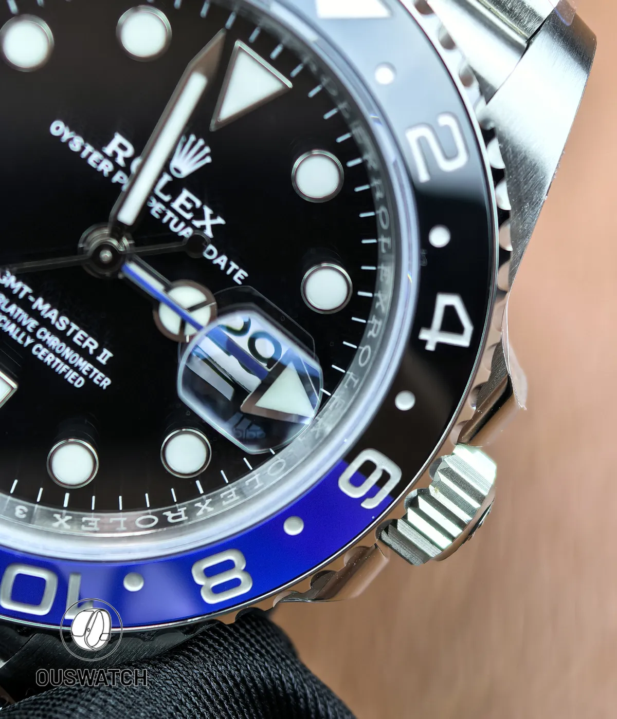 Tight view of the bezel edge and dial elements on the 126710BLNR, highlighting engraved numerals and applied markers.