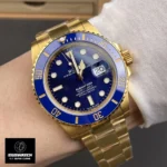 Close-up wrist shot of Rolex Submariner 126618LB-0002 yellow gold blue dial showing fit and finish.