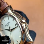 Close-up of the crown on Patek Philippe Calatrava 5227R-001 — knurling and logo visible.