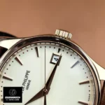 Partial close-up showing date window, bezel edge, crown and hands on Patek Philippe Calatrava 5227R-001.