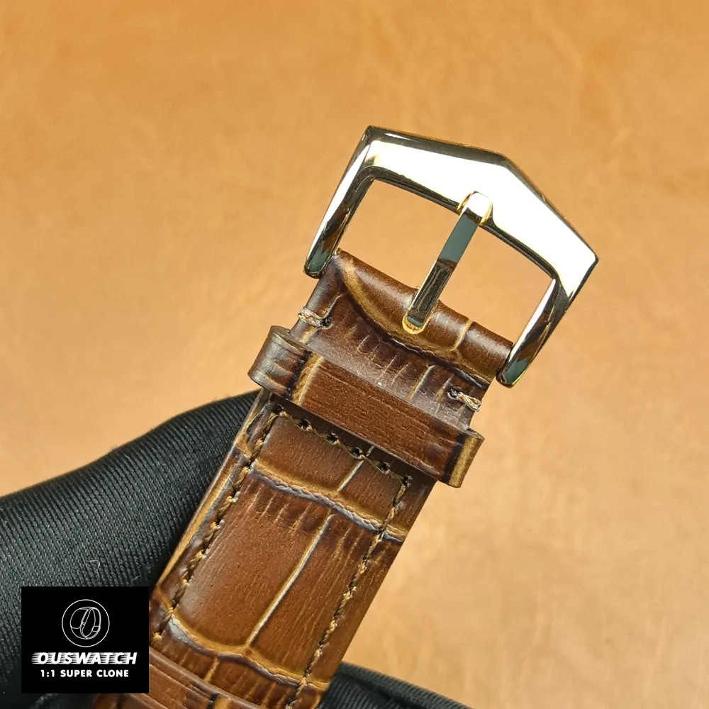 Rose gold tang (pin) buckle of Patek Philippe Calatrava 5227R-001 — buckle shape and stitching visible.