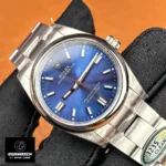 130° angled close-up of the blue sunburst dial capturing applied hour markers and radial light play.