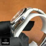 Detail of the case and signed screw-down crown, emphasizing crown knurling and crown-guard profile.