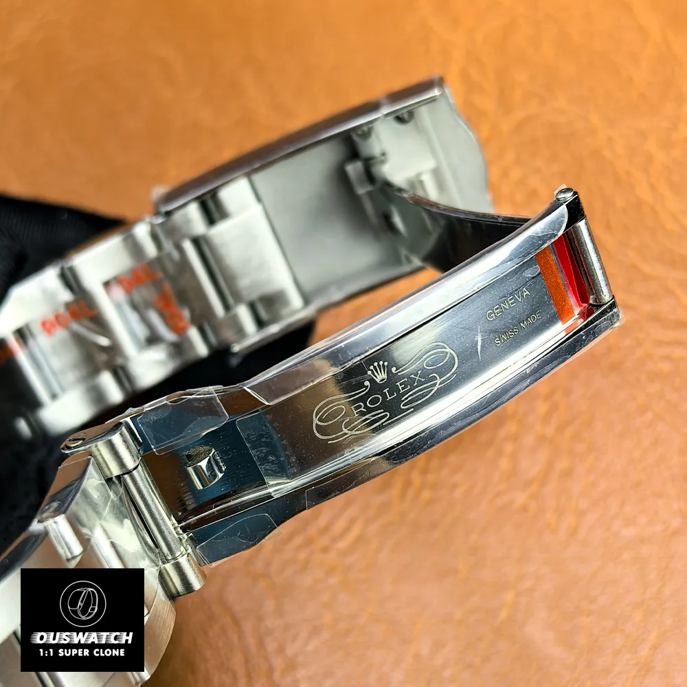 Folding clasp opened to display the Oysterclasp mechanism, stamped markings and locking geometry.