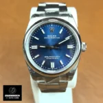 Straight-on front view of the Oyster Perpetual 36 showing the blue dial, polished bezel and centered handset.