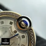 Blue cabochon crown detail on Cartier Ballon Bleu 33mm rose gold women's watch.