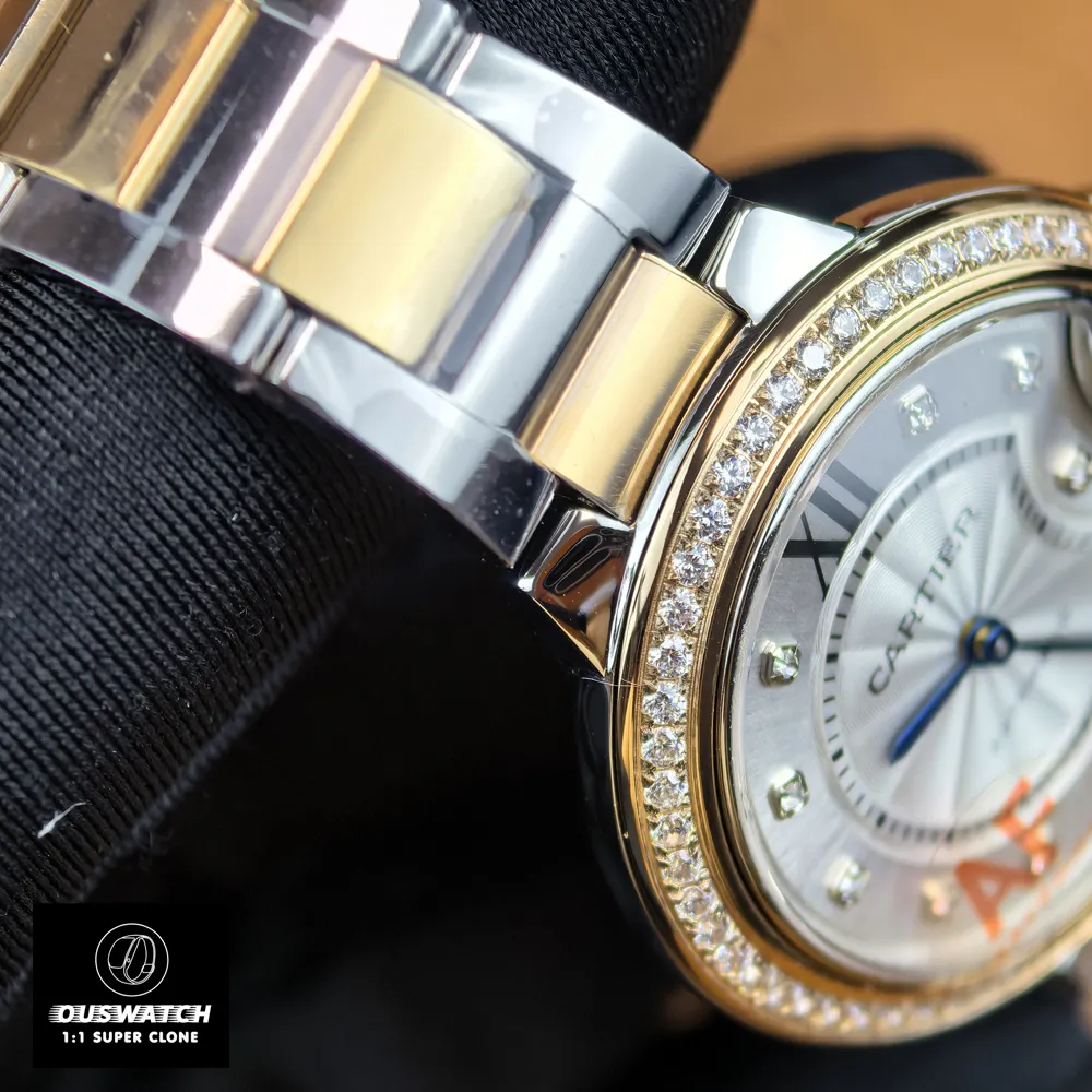 Detail shot of the rose gold and steel two-tone bracelet links on Cartier Ballon Bleu 33mm watch.