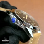 Side view of the crown on the Patek Philippe Calatrava 5226G-001 — crown guards and knurling visible.