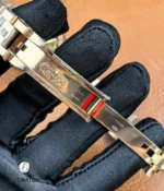 Folded deployment clasp opened and extended on Rolex Land-Dweller 127335-0001 — extension mechanism visible.