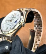 Macro shot of the crown on Rolex Land-Dweller 127335-0001 — knurling, crown guards and logo detail.