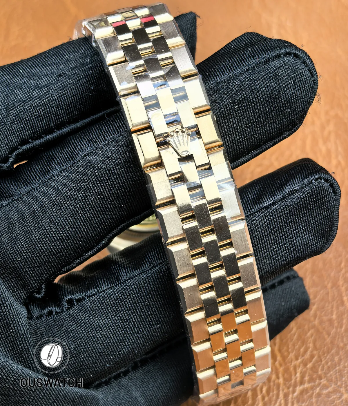 Full view of the rose gold bracelet for Rolex Land-Dweller 127335-0001 showing links and clasp area.