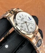 Side profile showing the bezel and case of Rolex Land-Dweller 127335-0001 — case edge and bezel details.