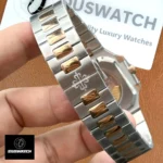 Close-up of the rose gold and steel two-tone bracelet on a Patek Philippe Cubitus 5821/1AR, showing link design and finish.