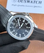 Detailed view of the black textured dial of the Aquanaut 5167A-001 PPF super clone, showing hour markers and dial texture