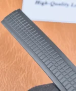 Black rubber strap for the Aquanaut 5167A-001 PPF super clone laid flat, showing the textured surface and taper.