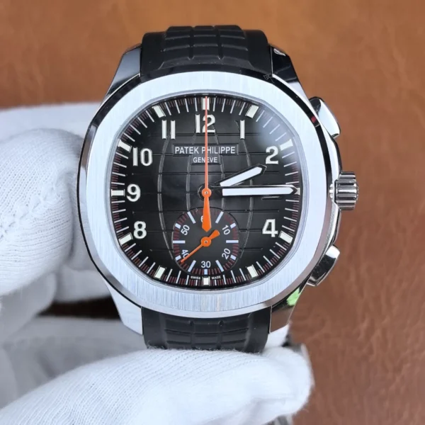 Close-up front view of the Patek Philippe Aquanaut 5968A-001 chronograph watch, highlighting the black embossed dial and orange chronograph hand